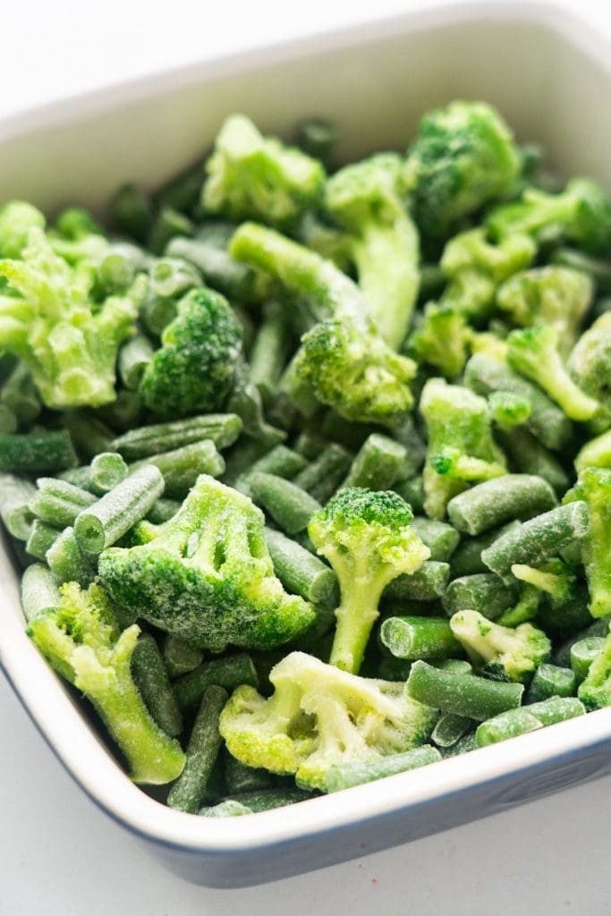 frozen green beans and broccoli in casserole dish.