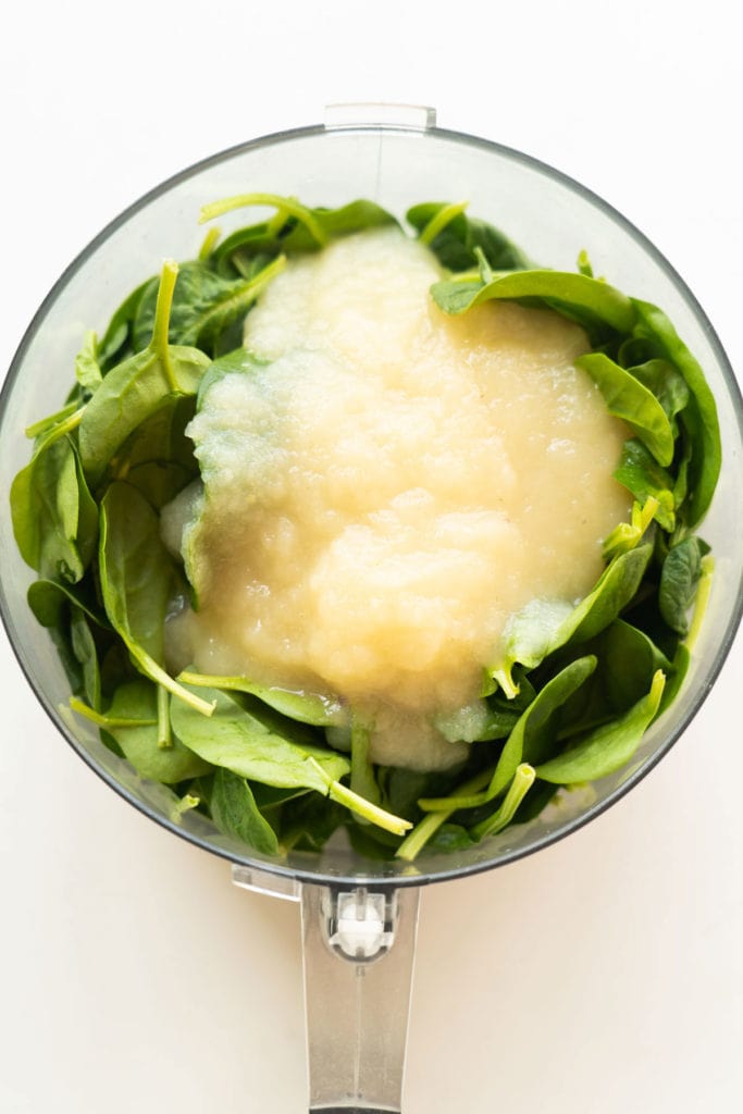 Spinach and applesauce in food processor.
