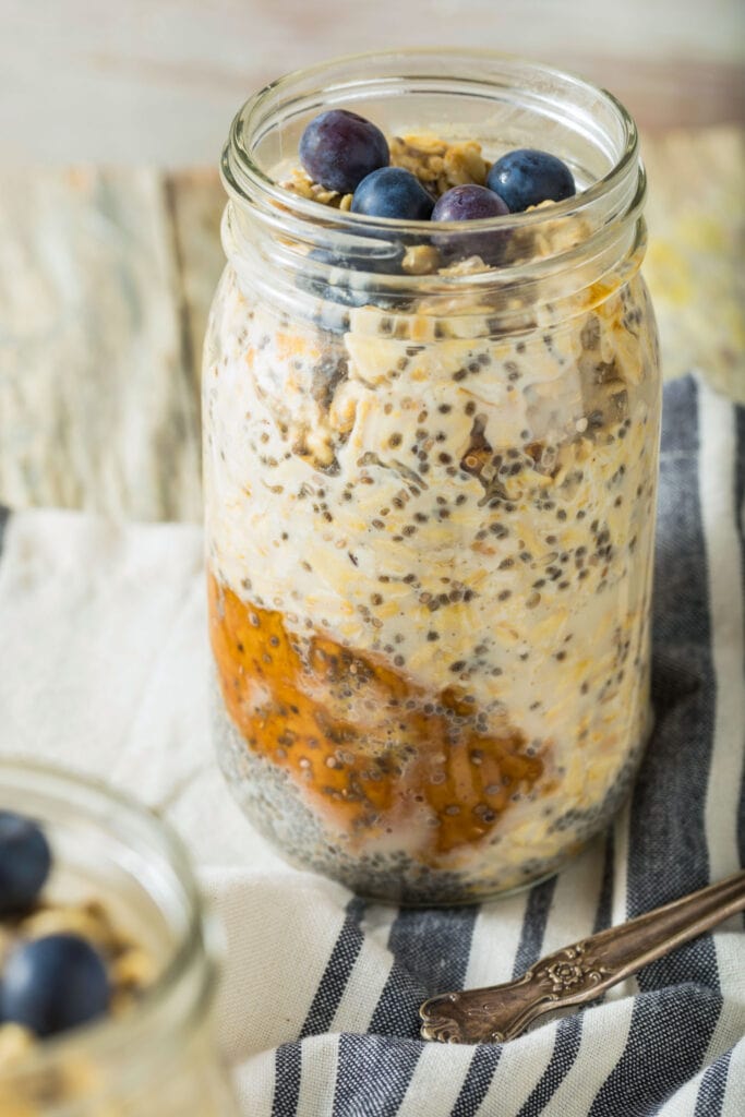 overnight oats in glass jar on table.