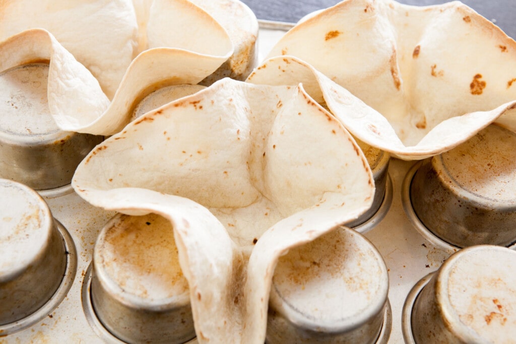 tortilla shells on upside down cupcake pan.