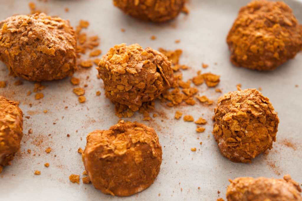 ice cream balls on waxed paper with cornflakes sugar mixture.