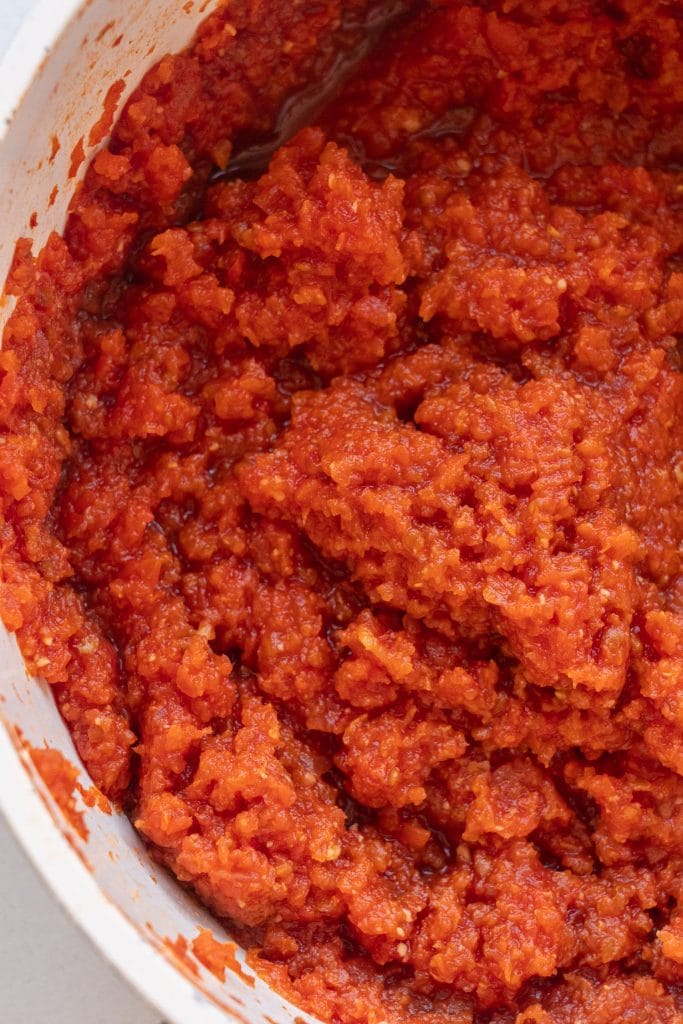 red tomato paste simmered down in pot.