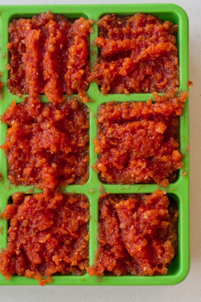 tomato paste in freen ice cube trays.