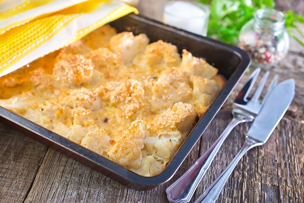 Easy Cheesy Cauliflower Casserole is delicious and only takes 10 minutes to prepare! This loaded casserole recipe is made with Cheddar and Parmesan to make it extra cheesy!  My family declares it one of their favorite side dishes on the holiday table! Low carb friendly. 