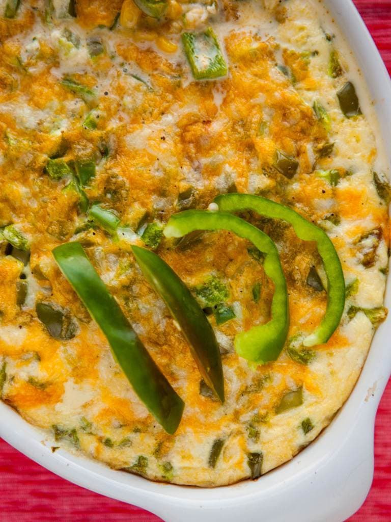 slices of green peppers on top of baked casserole in baking dish.