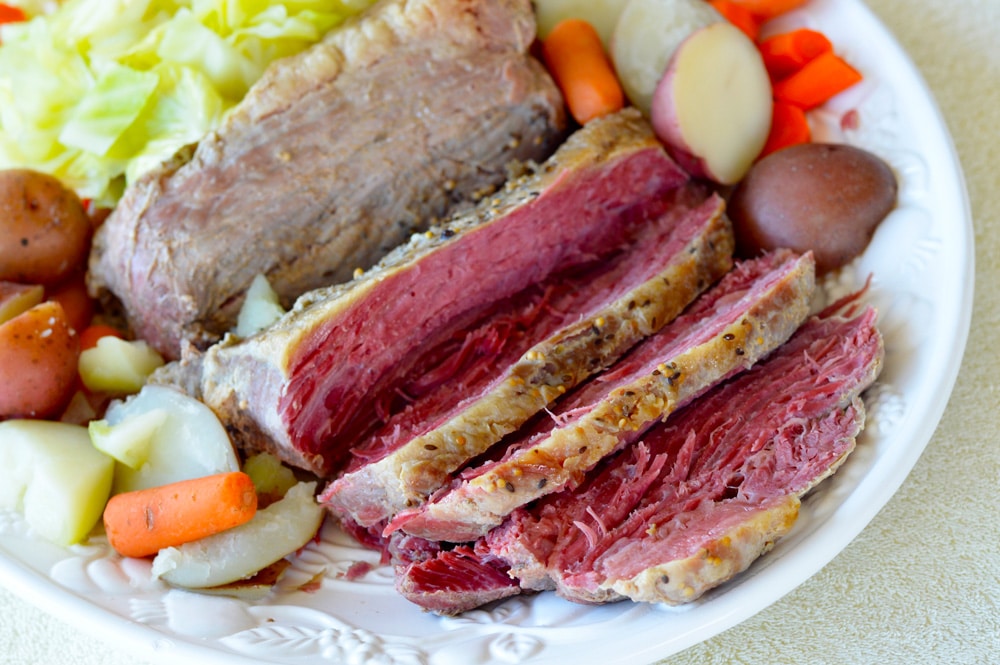 DELICIOUS CROCK POT Corned Beef Brisket with Vegetables recipe!  This slow cooker recipe cooks a 4 pound corned beef brisket with cabbage, carrots, potatoes and onion to create a amazing dinner! Use the leftovers the next day for the best BBQ sandwiches!