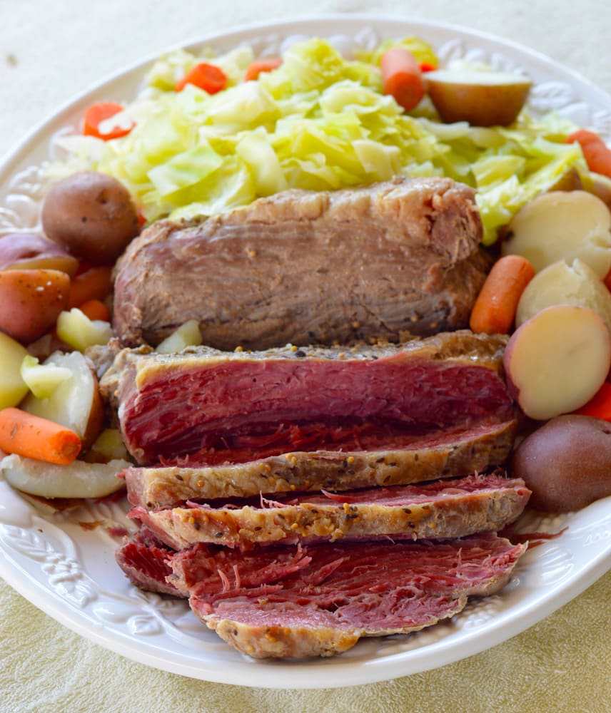 DELICIOUS CROCK POT Corned Beef Brisket with Vegetables recipe!  This slow cooker recipe cooks a 4 pound corned beef brisket with cabbage, carrots, potatoes and onion to create a amazing dinner! Use the leftovers the next day for the best BBQ sandwiches!