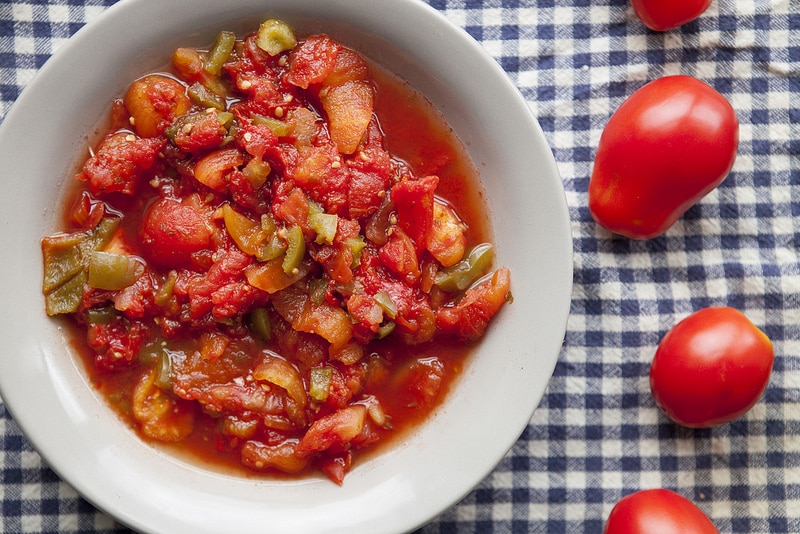 The BEST Stewed Tomatoes Ever recipe!  This easy to make recipe simmers tomatoes for 30 minutes to make homemade stewed tomatoes that can be served as a dinner side dish or can be canned.  This how to make recipe shows you how easy they are to make! Find out why everyone considers them THE BEST!   We always use this as a canning recipe for our Summer garden tomatoes! 