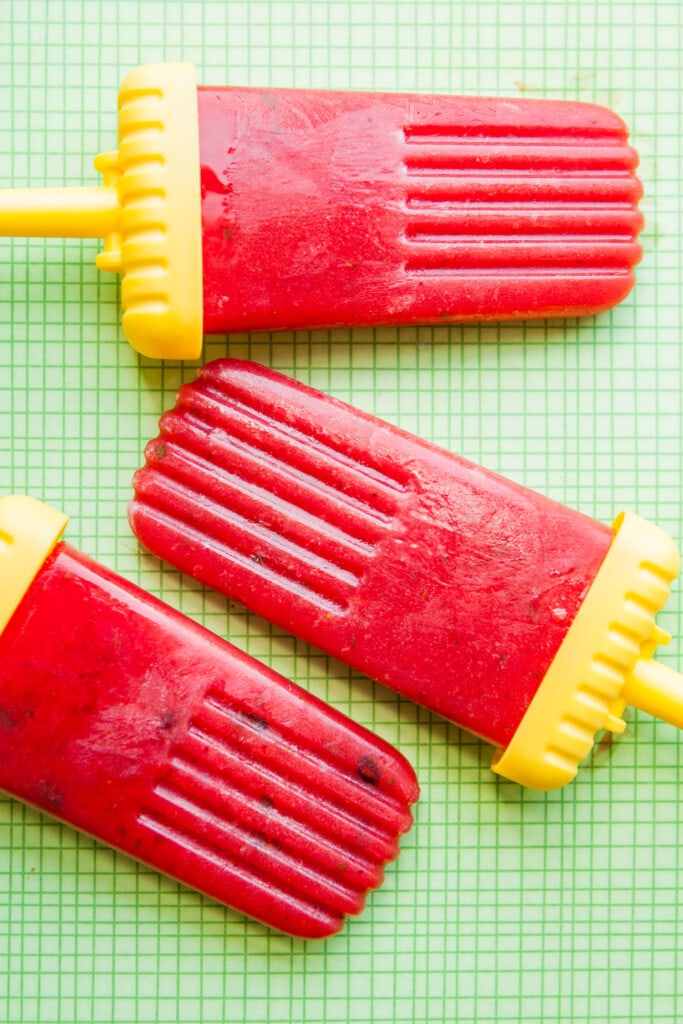 red watermelon strawberry popsicles in yellow popsicle mold. 