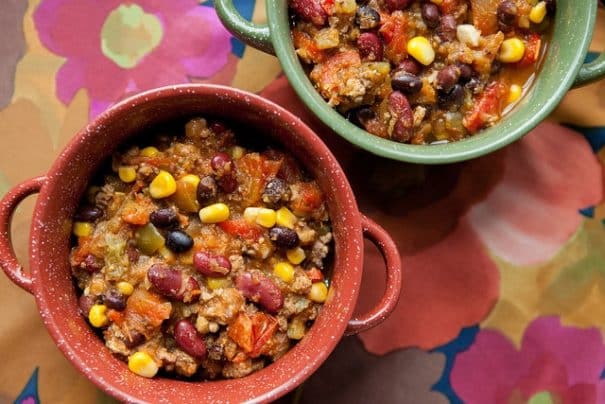 EASY Slow Cooker Pumpkin Chili is packed full of pumpkin, ground turkey, beans, vegetables and Mexican spices. This healthy, hearty chili is perfect for chilly fall and winter nights. Serve this pumpkin chili with cornbread or tortilla chips and your favorite toppings. And be sure to keep this recipe in mind for a football watch party, game night, or office potluck!