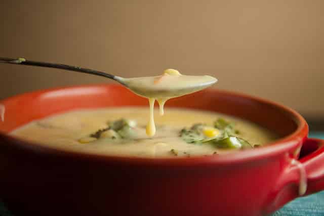 This Creamy Broccoli Cheese Soup recipe is a family favorite! I love serving it as comfort food on a cold night!  This soup is made with broccoli, carrots and Velveeta cheese!