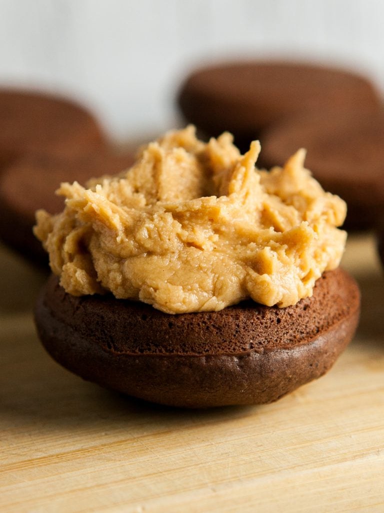 peanut butter frosting on the top of one side of a whoopie pie.