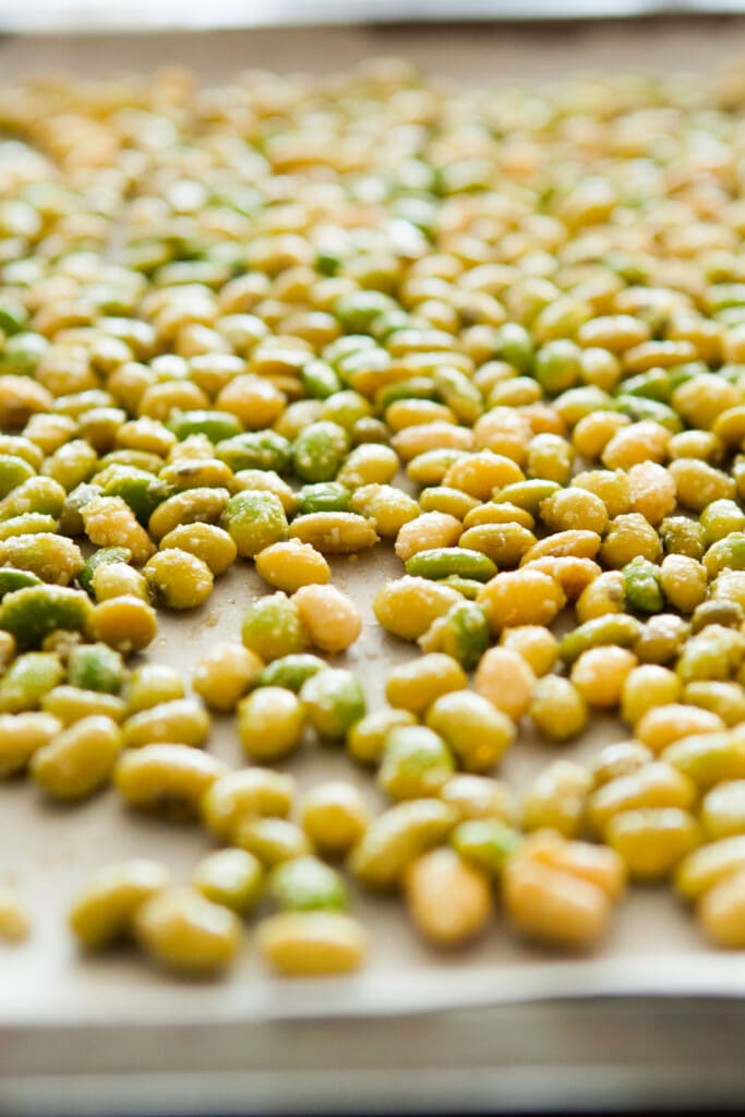 fresh soybeans with seasonings on them before being baked.