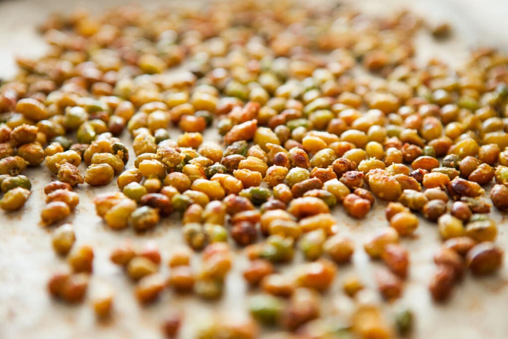 Roasted soybeans on baking sheet.