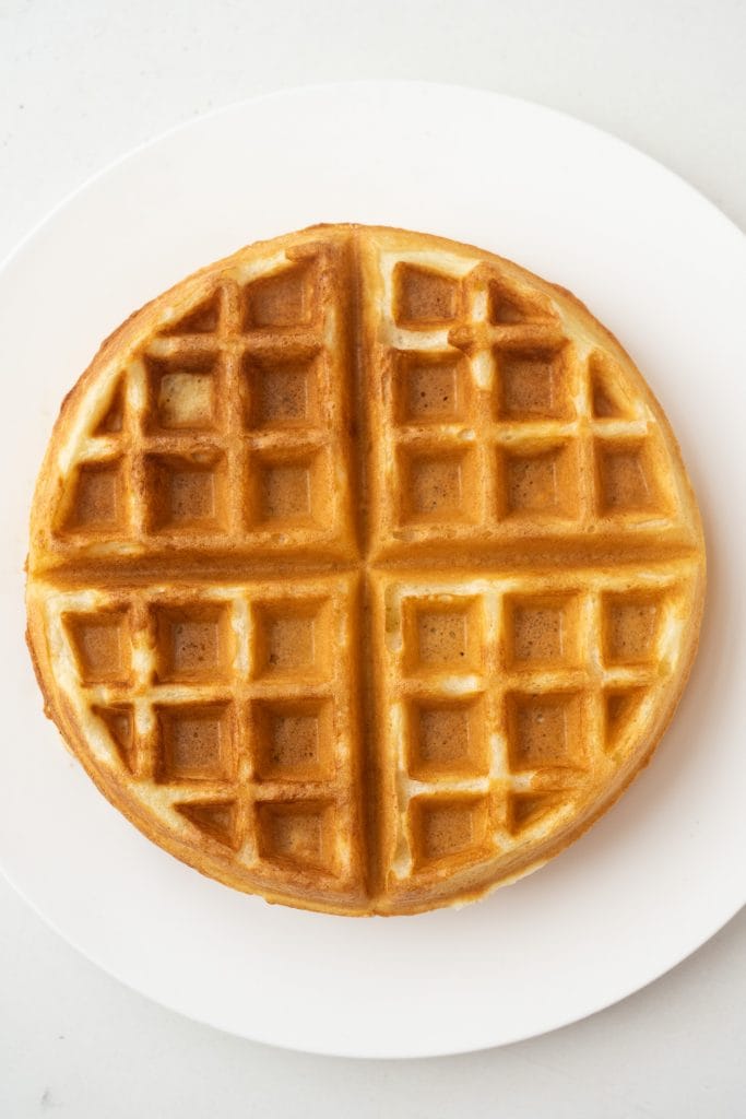 buttermilk waffle on plate on table.