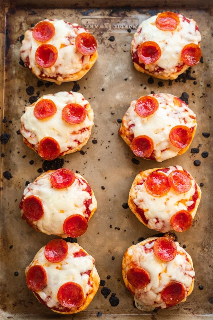 mini pizzas baked on baking sheet.