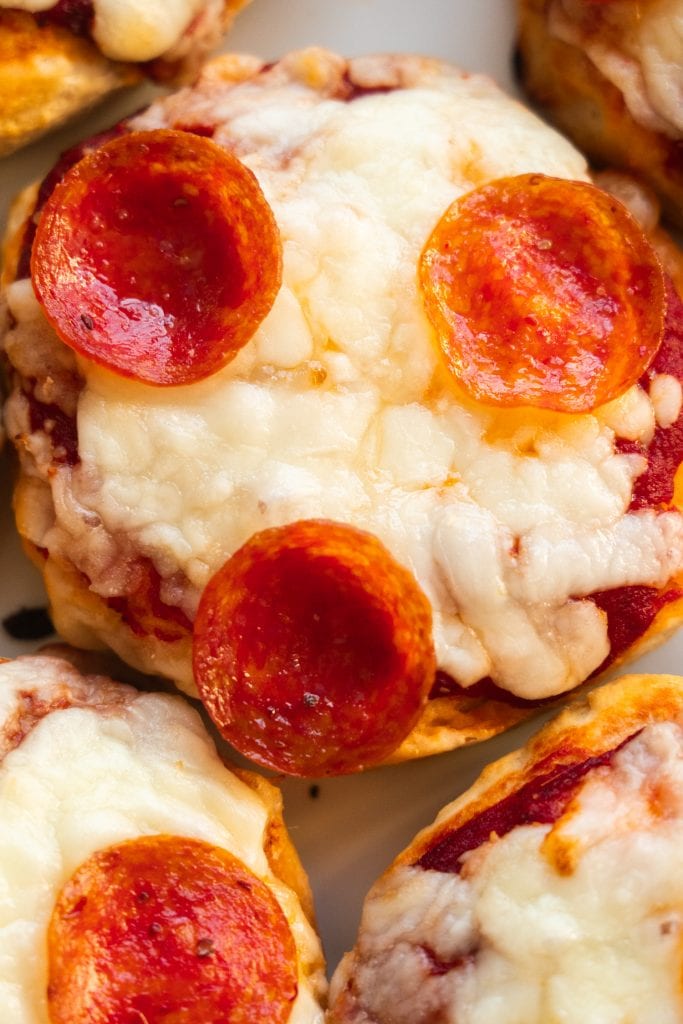 closeup of cheesy mini pizza with pepperoni.