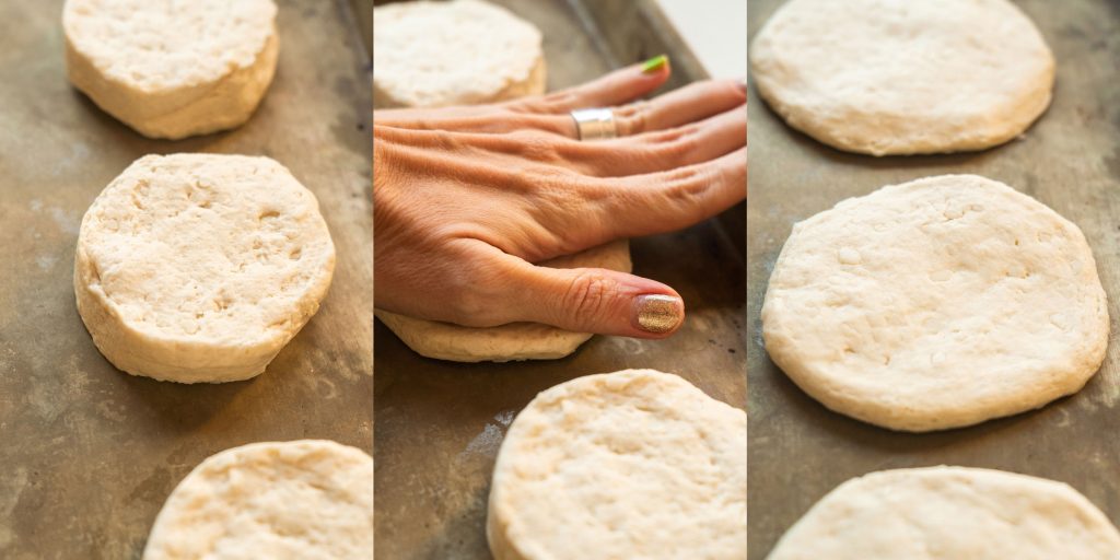 hand flattening down biscuit dough.