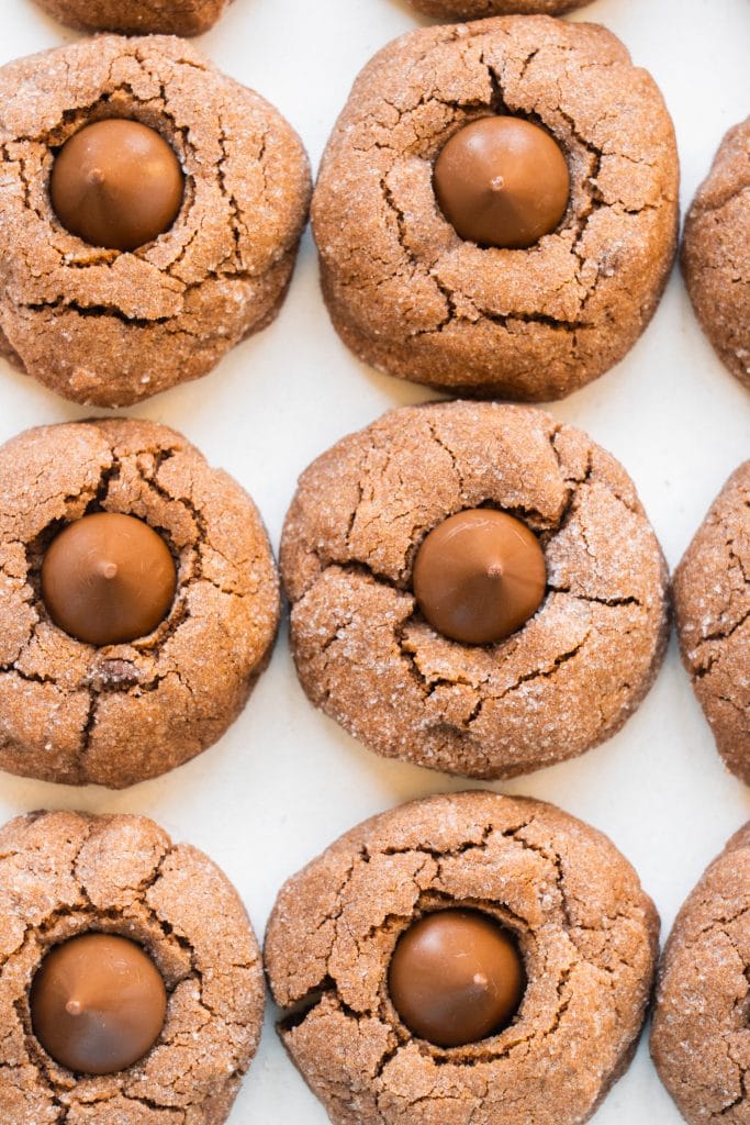 chocolate peanut butter blossoms on white table. 