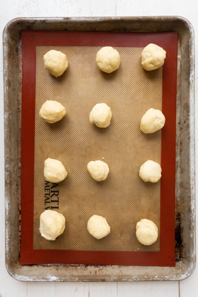 balls of cookie dough on baking sheet.
