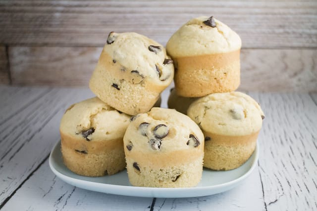 FLUFFY and EASY to make Chocolate Chip Muffins! This homemade recipe is my family's favorite! It makes delicious, moist muffins that are filled with chocolate chips! Make these light tasting yummy muffins for breakfast, snacks on the go or dessert!