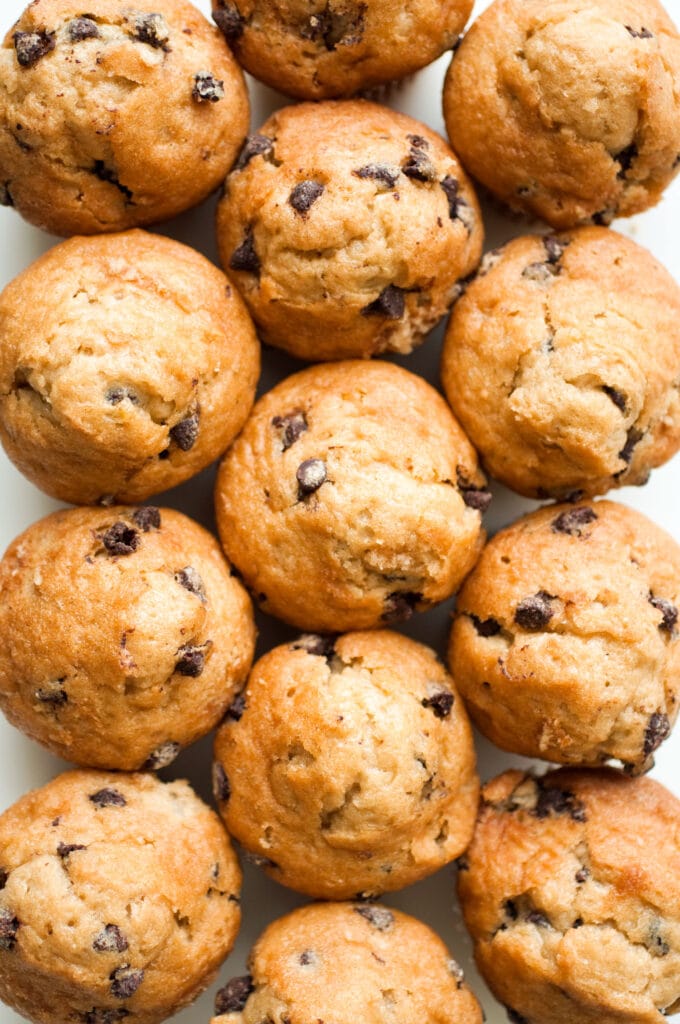 overhead shot of chocolate chip muffins on table.