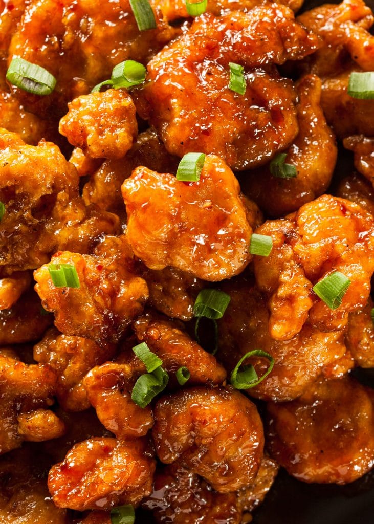 saucy general tsos chicken with green onions.