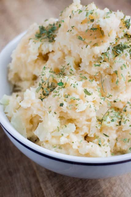 Creamy Cauliflower Mashed Potatoes - these are just like mashed potatoes but instead uses no potatoes or milk! This will be your new favorite side dish recipe for Thanksgiving and Christmas dinner!