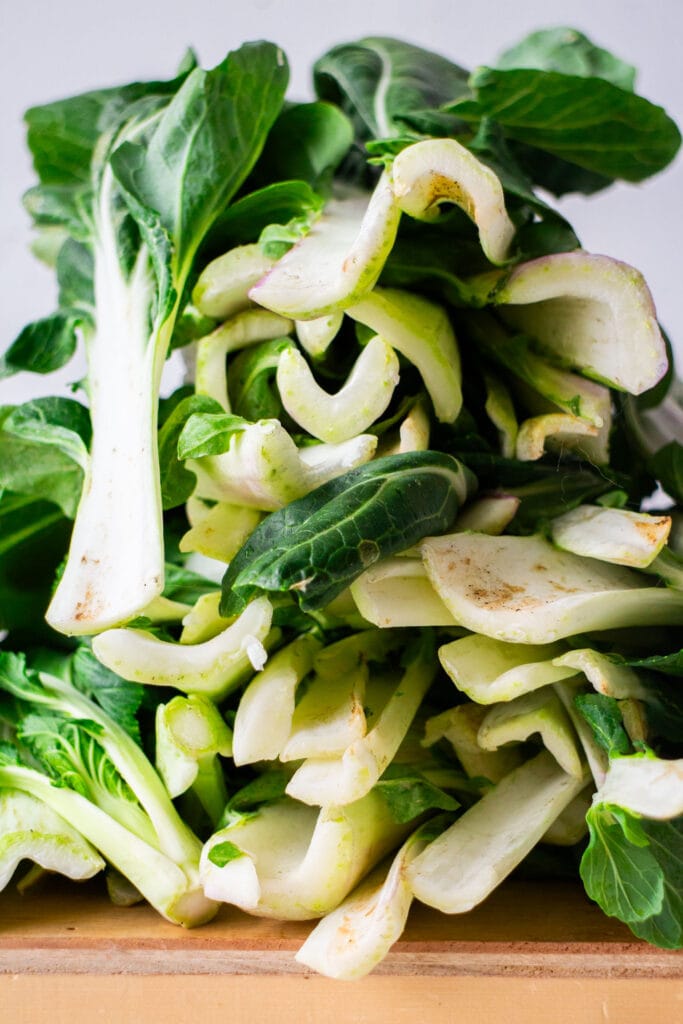 large stack of bok choy on table.