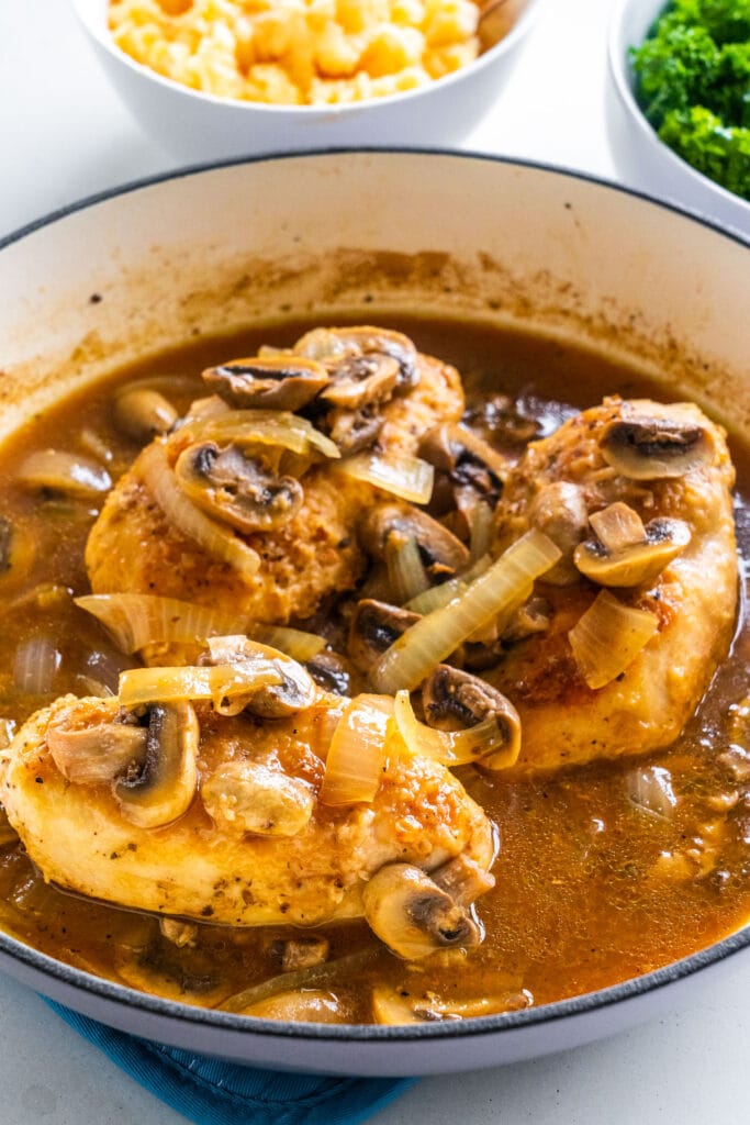 cooked chicken marsala in pan with gravy in it.