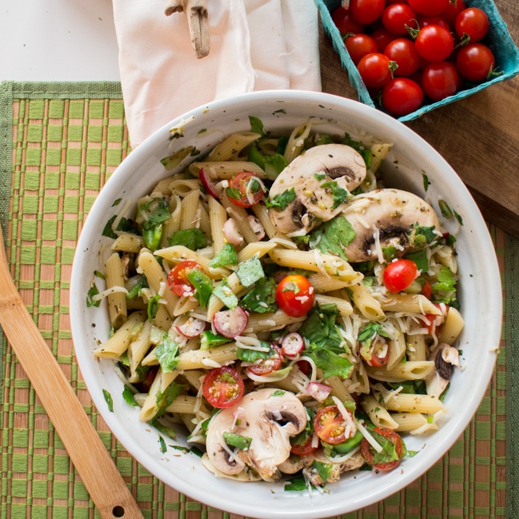 Fresh Pasta Salad recipe that tastes just like Summer! Recipe ingredients include cherry tomatoes, radishes, green pepper, lettuce and mushrooms! This is perfect for a healthy dinner or picnic lunch. 