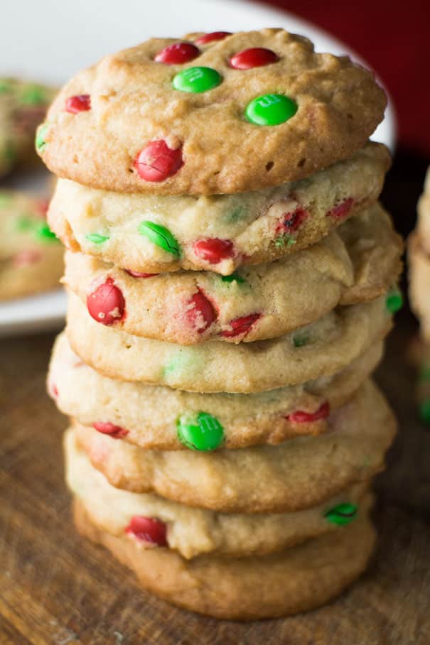 These M&M Christmas Cookies are made with a simple, delicious sugar cookie dough and plenty of chocolate candy pieces. A fun and festive treat for cookie exchanges and gift giving that can easily be customized to suit your occasion!