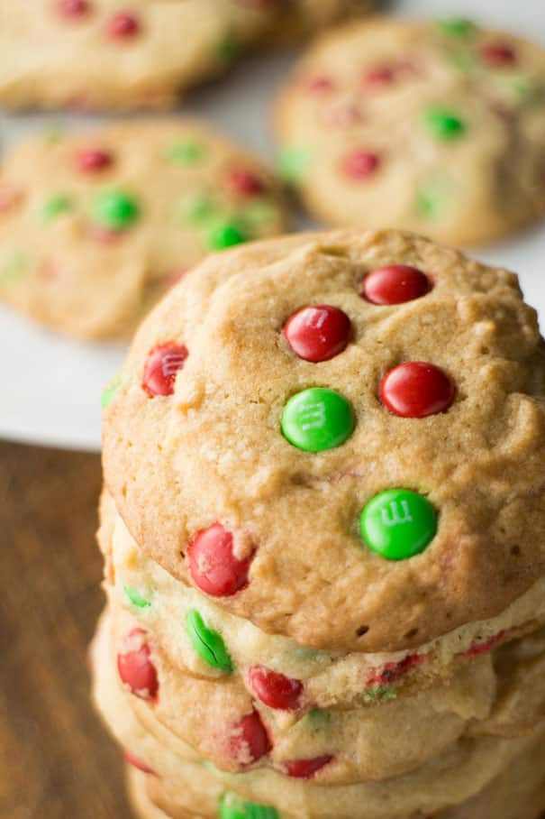 These M&M Christmas Cookies are made with a simple, delicious sugar cookie dough and plenty of chocolate candy pieces. A fun and festive treat for cookie exchanges and gift giving that can easily be customized to suit your occasion!