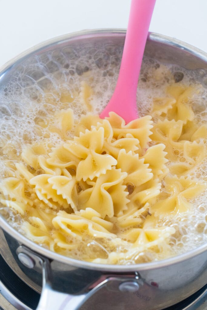 bow tie pasta boiling in saucepan.