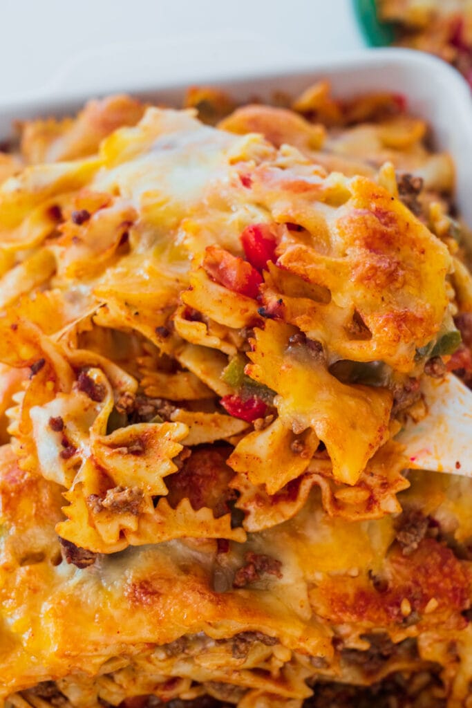 spatula lifting up taco casserole out of baking dish.