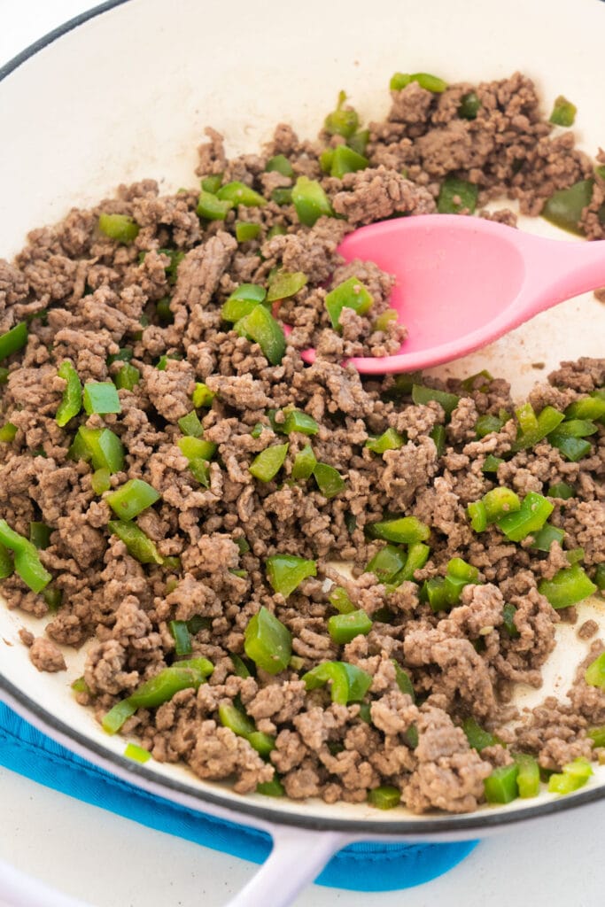 ground beef and pepper being browned in skillet.