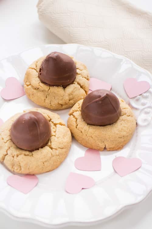CHOCOLATE covered CHERRY cookies! Easy recipe for Peanut Butter Blossom Cookies with a chocolate covered cherry in the middle of each one! The cookies are so soft and chewy, that kids and adults will consider them the best! These are great cookies for Valentines Day, Christmas and parties!