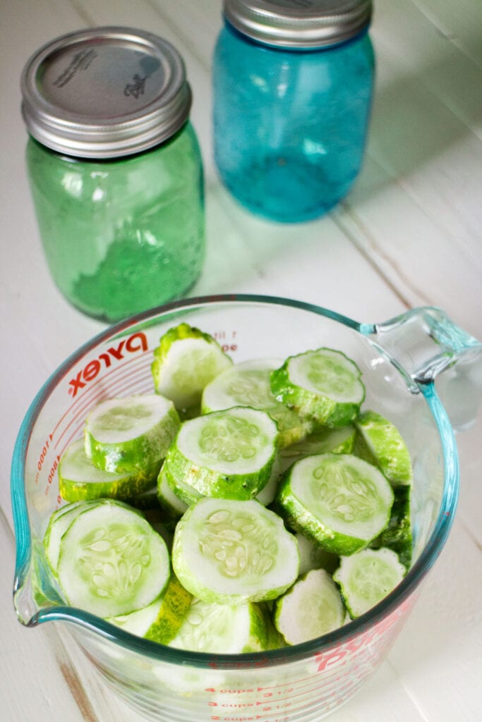 sliced cucumbers in large measuring cup.
