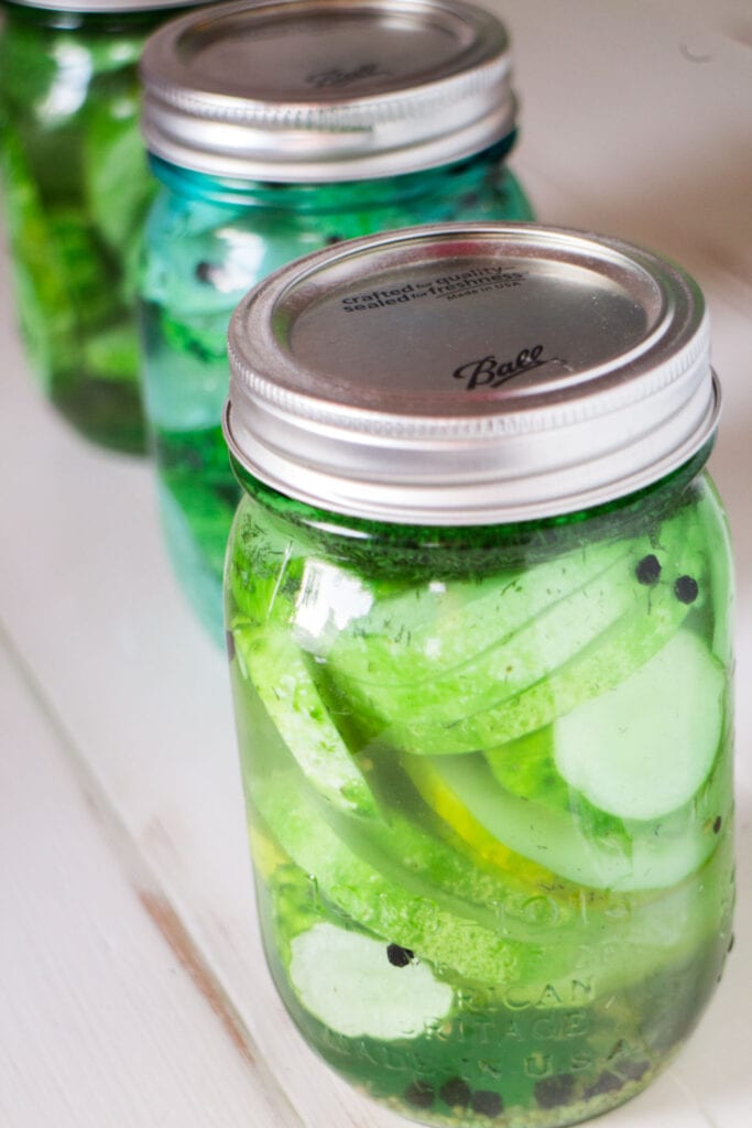 sliced dill pickles in mason jars.