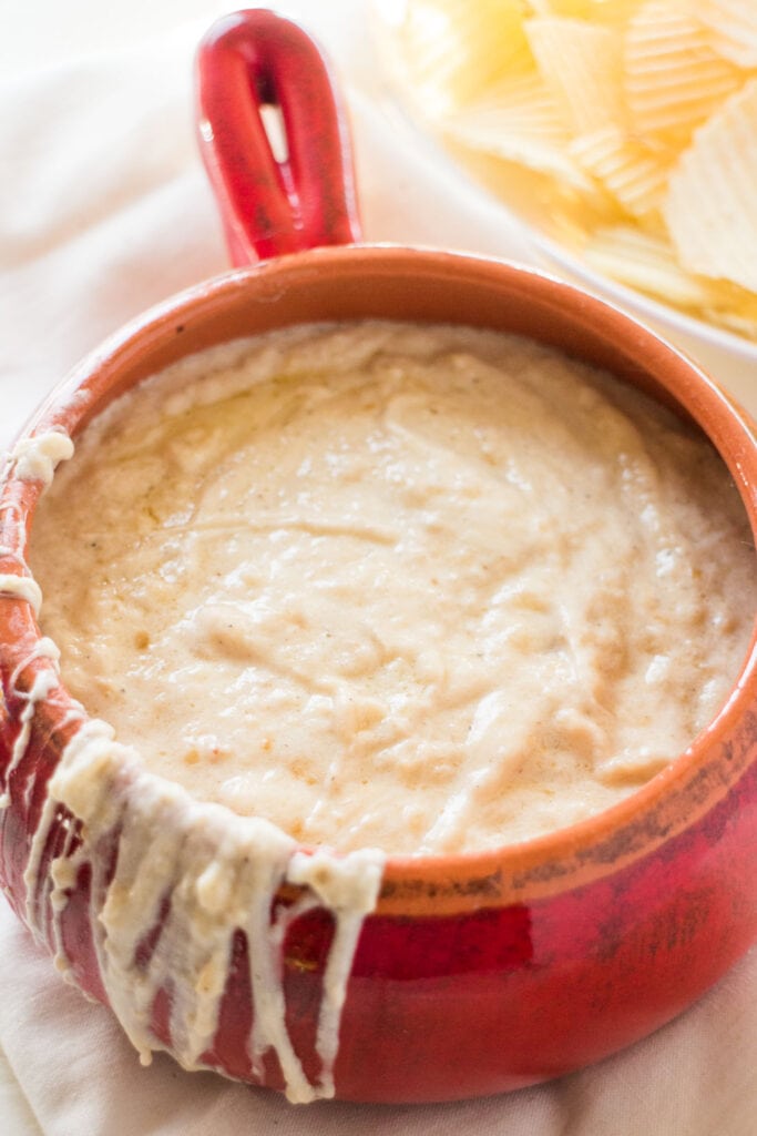 bowl of cheesy onion dip on table.