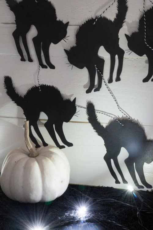 DIY on how to make black cat Halloween garland. Super easy to make with a die cut machine or laser cutter. All you need is paper and string!
