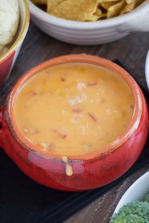 EASY MEXICAN Cheddar Cheese Dip made with 1 bag of shredded cheese, milk and other simple ingredients. This delicious dip can be served with tortilla chips, crackers, vegetables or on top of nachos! It's always the hit of the party!