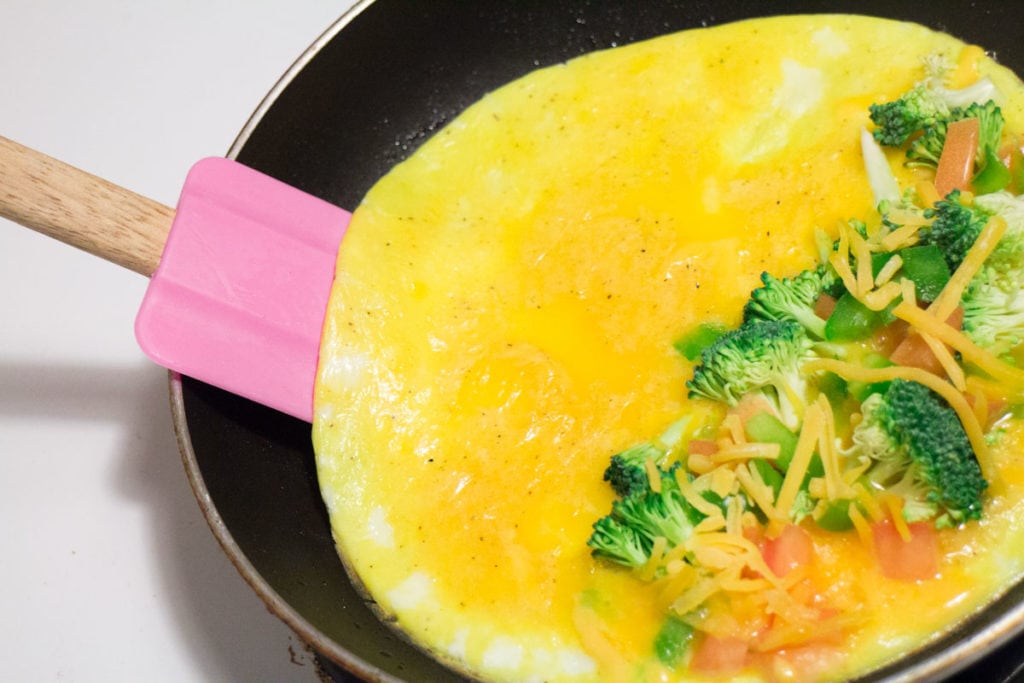Cooking omelette in frying pan