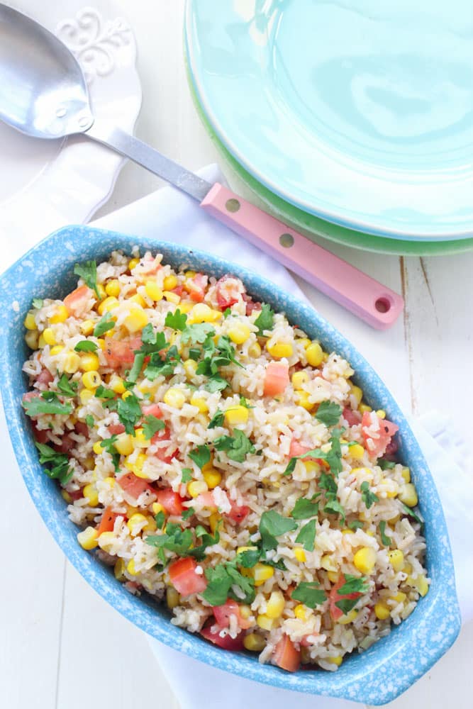 This Corn and Tomato Rice Salad is a healthy recipe for dinner, picnics and potlucks.  With it's Mexican inspired flavor it'll be a hit with everyone!  And even better, it's easy to make in 15 minutes!