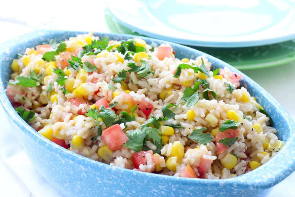 This Corn and Tomato Rice Salad is perfect for dinner, picnics and potlucks. With it's Mexican inspired flavor it'll be a hit with everyone! And even better, it's ready in 15 minutes!