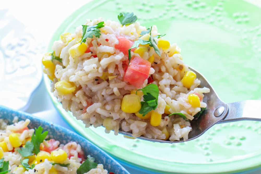 This Corn and Tomato Rice Salad is perfect for dinner, picnics and potlucks. With it's Mexican inspired flavor it'll be a hit with everyone! And even better, it's ready in 15 minutes!