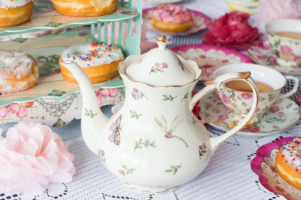 floral tea kettle on lace table cloth