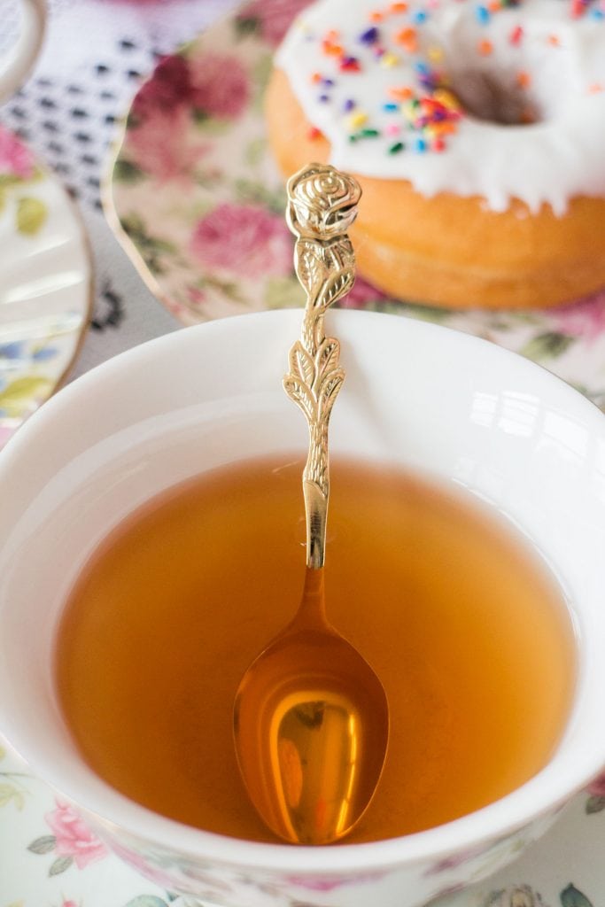 rose spoon in tea cup on table