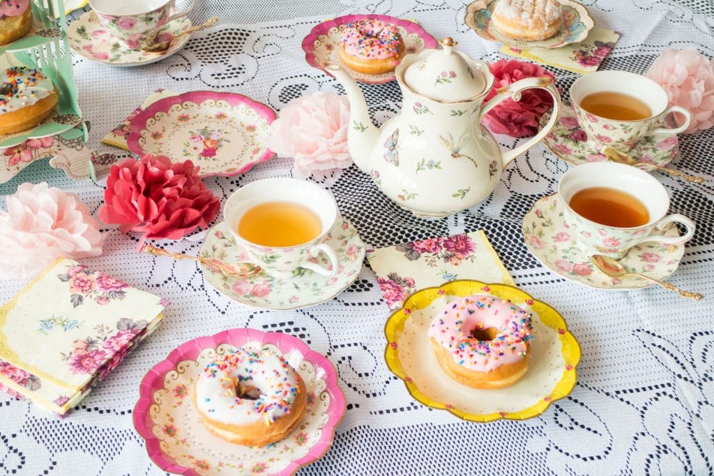 food and tea cups on lace table cloth for a tea party