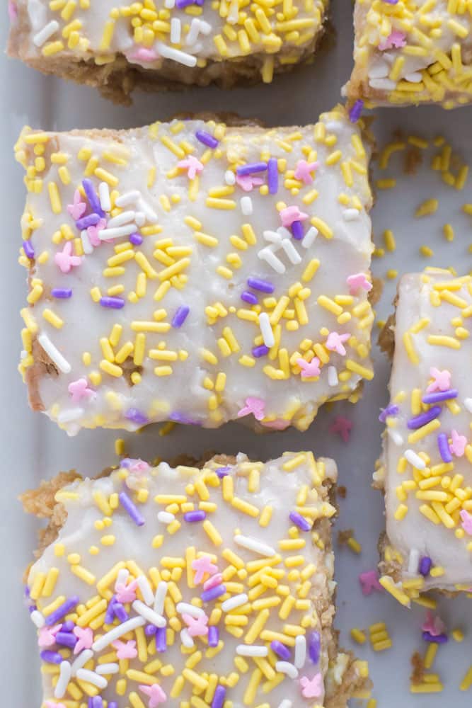 Delicious Vanilla Sprinkle Blondies with a vanilla glaze frosting on top is everyone's favorite treat! This easy dessert recipe makes fudgy, ooey gooey cake tasting vanilla brownies (blondies!). Add pretty sprinkles on top and they're perfect for a birthday party! 